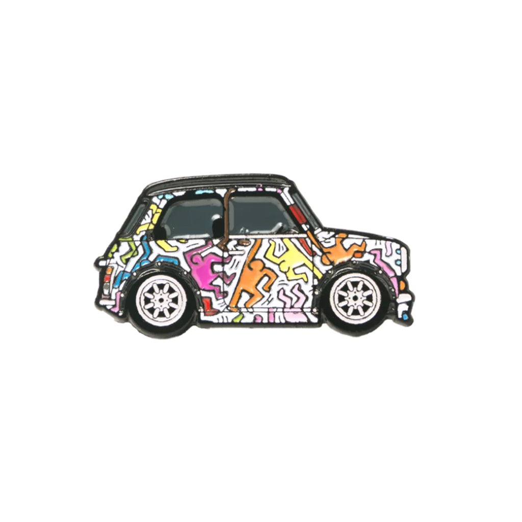 A soft enamel lapel pin depicting a Mini Cooper with a Keith Haring inspired livery.