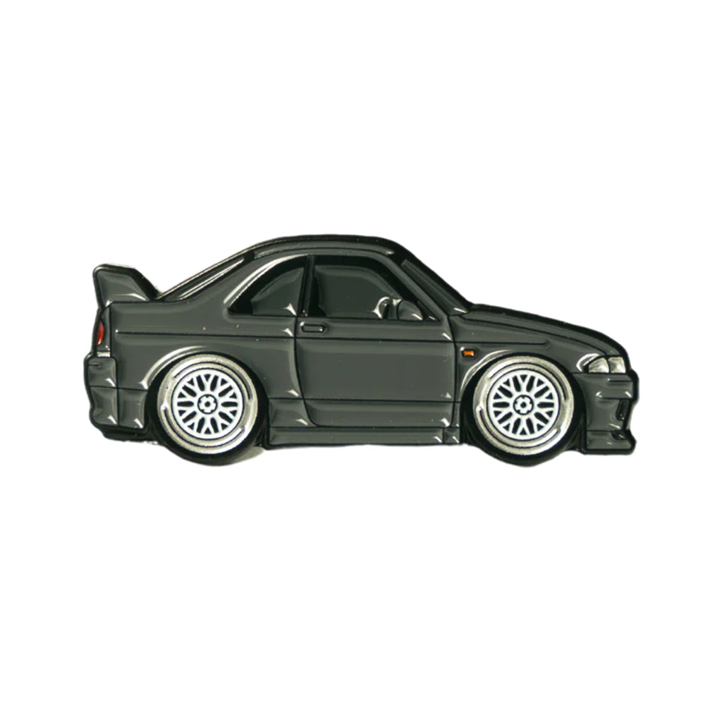 Soft enamel lapel pin of a charcoal colored Nissan Skyline R33