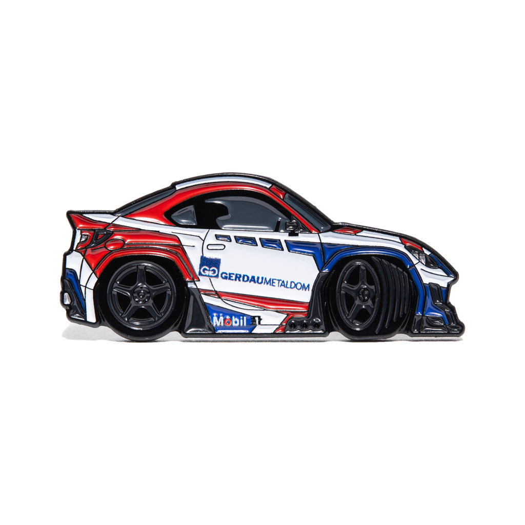 Metal enamel pin of drifter Jhonnattan Castro's FRS GR86. Colors: white, red, blue with black wheels.