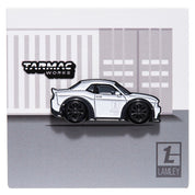 A limited edition white Dodge Charger pin by Leen Customs, in collaboration with Lamely group pinned to a square backing card. 