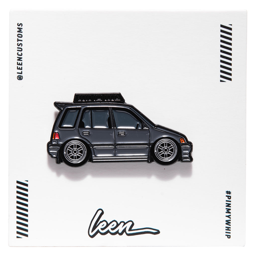 Metal enamel pin of an EF Wagon in grey with silver wheels and roof rack. On white open edition backing card with Leen logo.