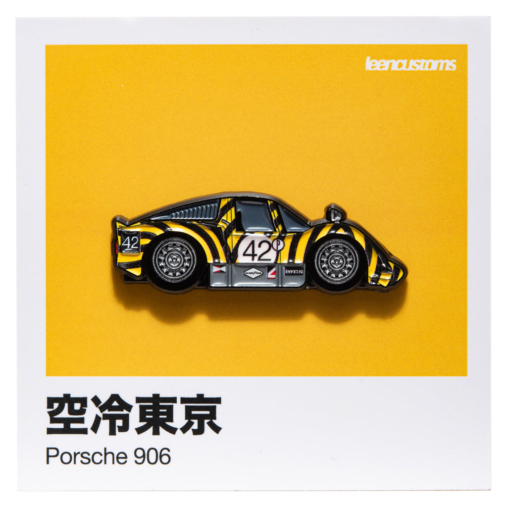 Porsche 906 in a black and yellow tiger livery, on a yellow collector card with Japanese text and Leen customs branding. 