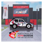 Enamel pin of Lancia Delta Integrale with Martini Racing livery in front of the Nationales Auto Museum backing card