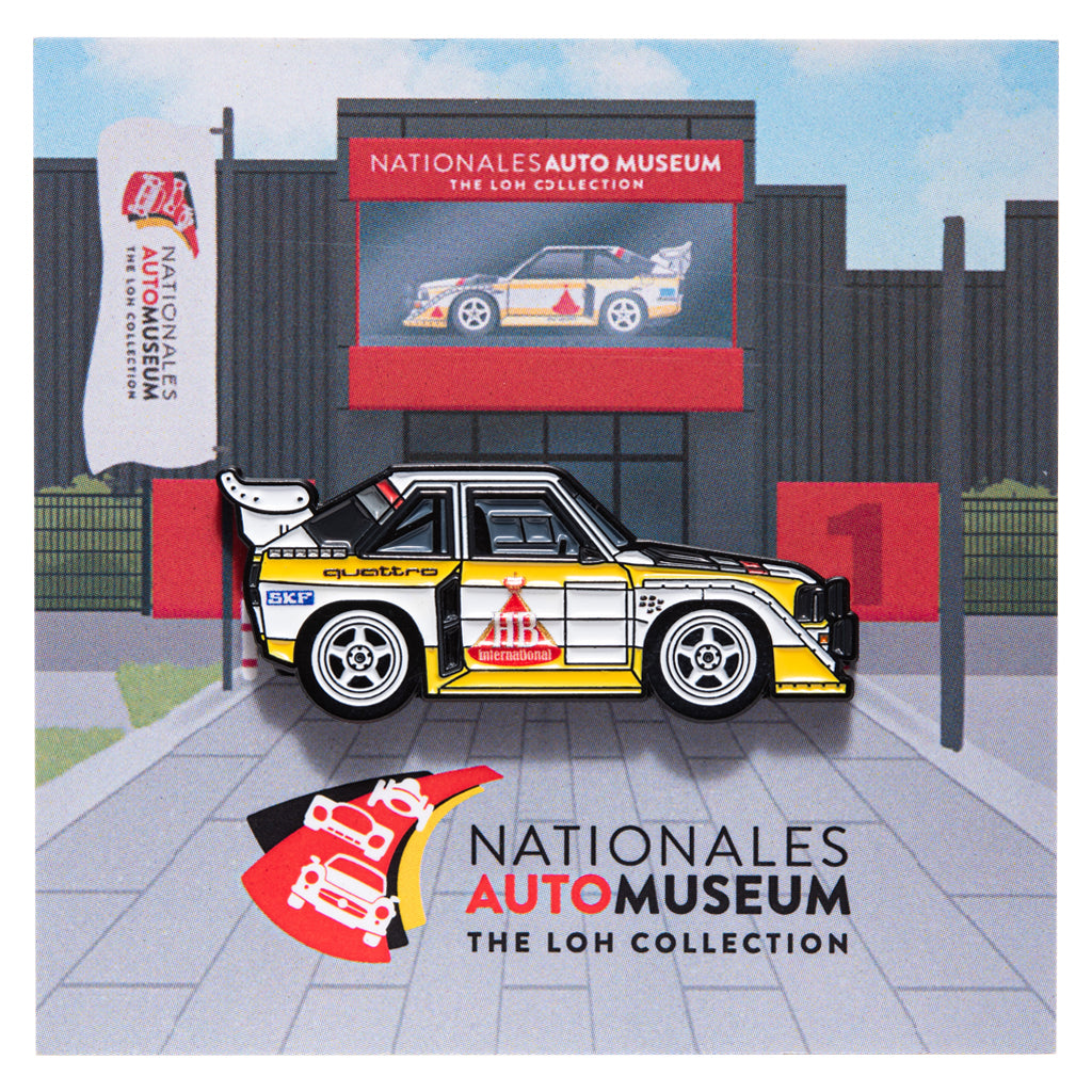 Enamel pin of Audi Sport Quattro S1 in front of Nationales Auto Museum backing card