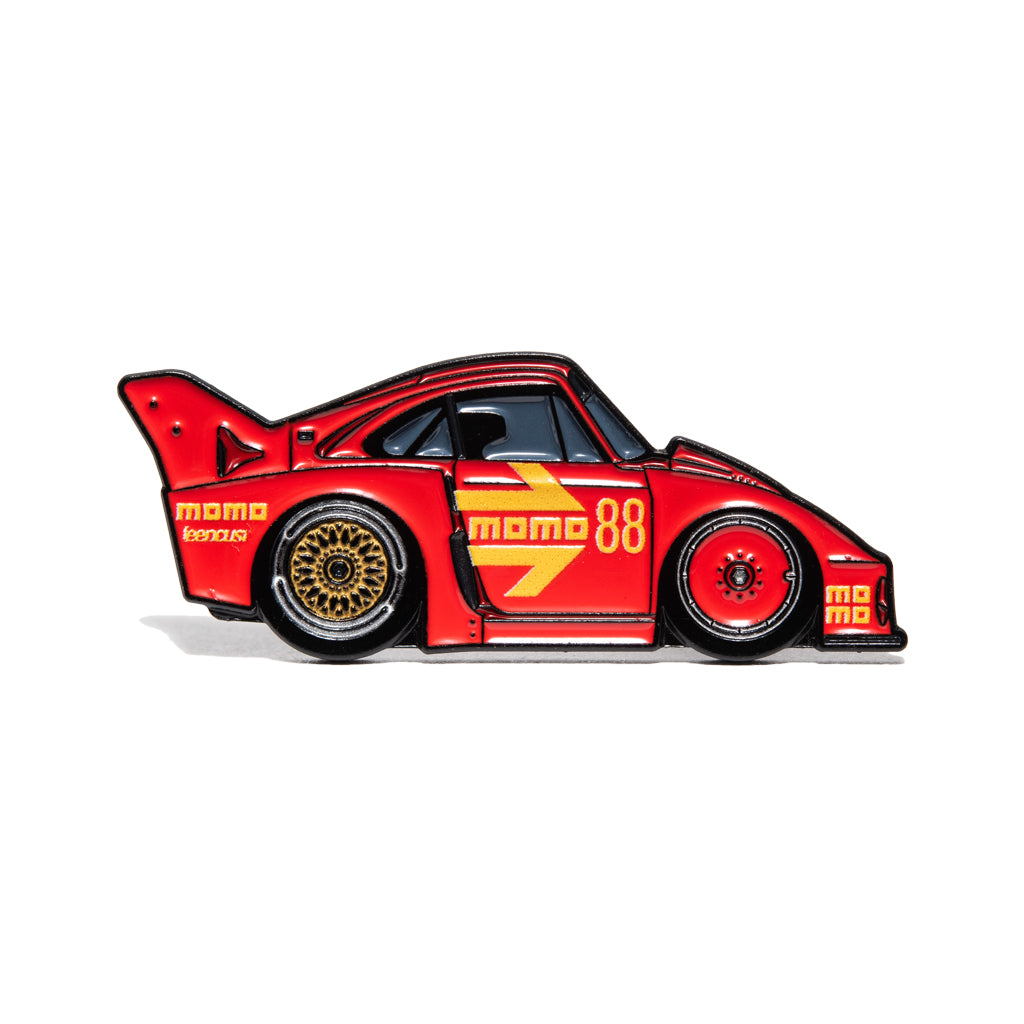 MOMO 935K inspired wide-body endurance race car enamel pin with classic red motorsport livery.