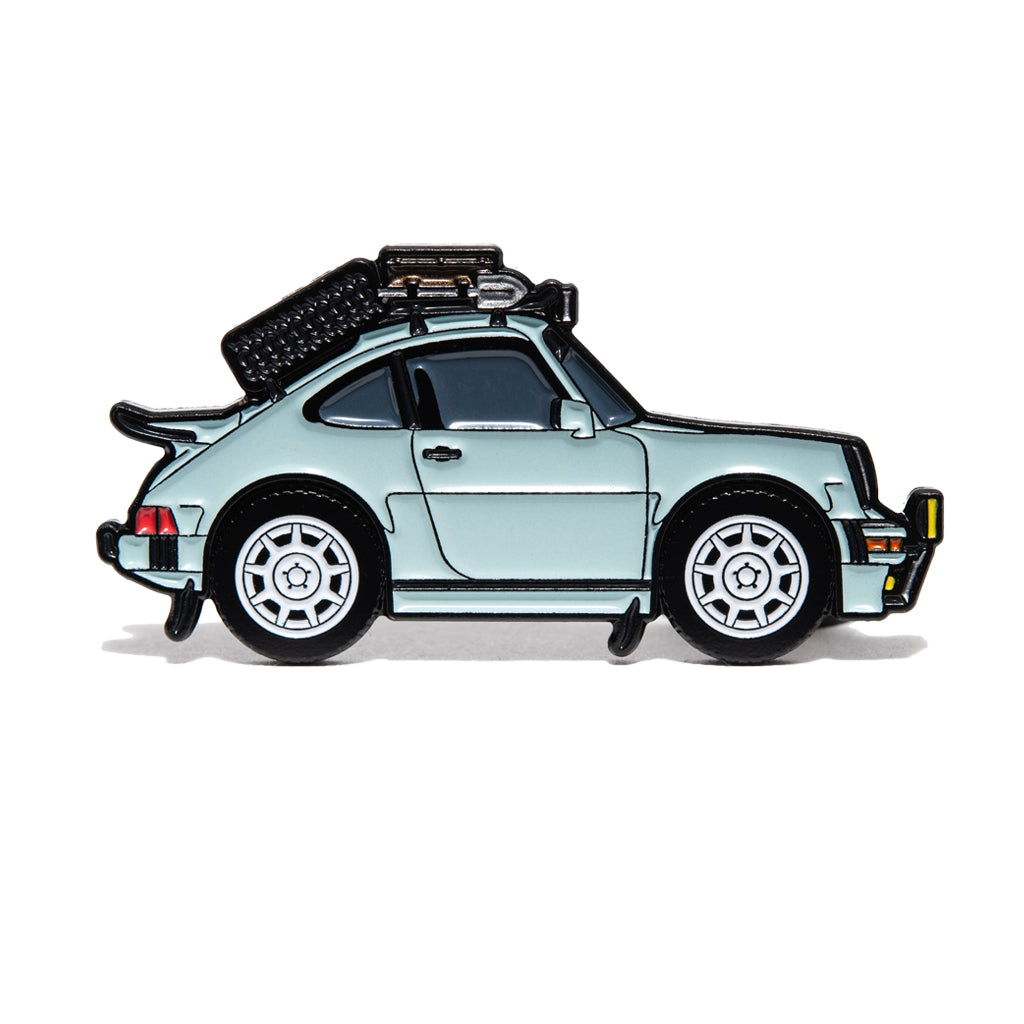 Light blue Porsche 911 Safari with a black roof rack, side profile on a white background