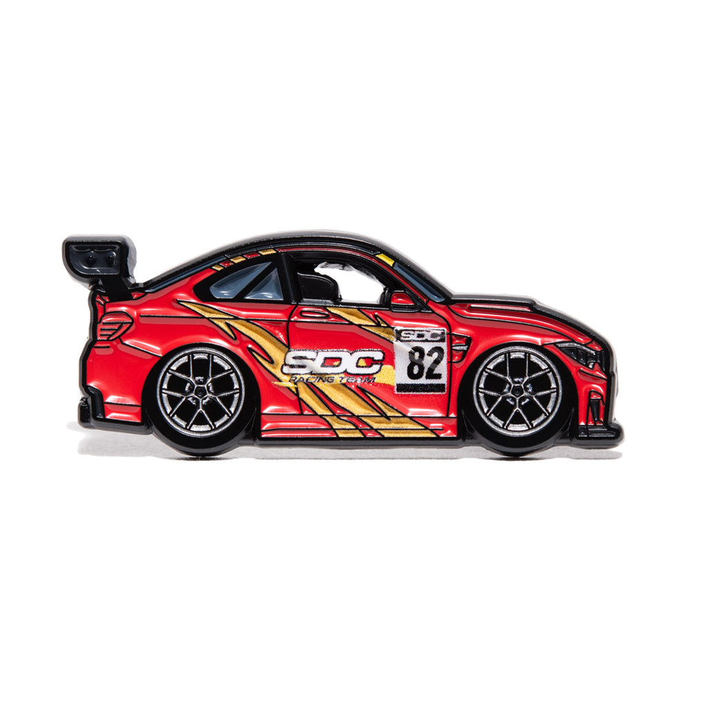 Red livery on a BMW F82 M4 enamel pin for SDC Racing Team