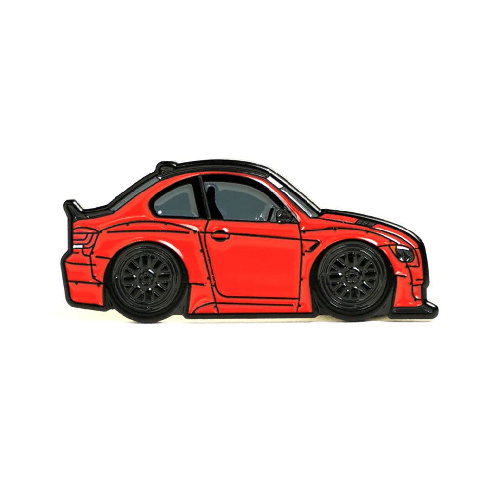 Soft enamel lapel pin of a red E92 BMW with widebody kit