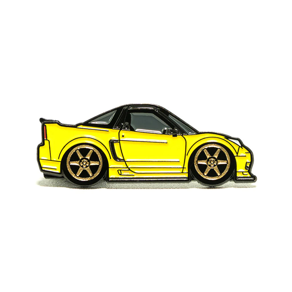 Soft enamel lapel pin of a yellow Acura NSX