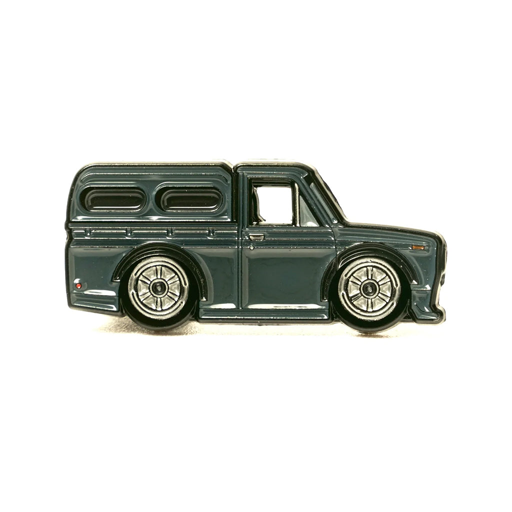 Soft enamel lapel pin of a Datsun 521 pickup with camper