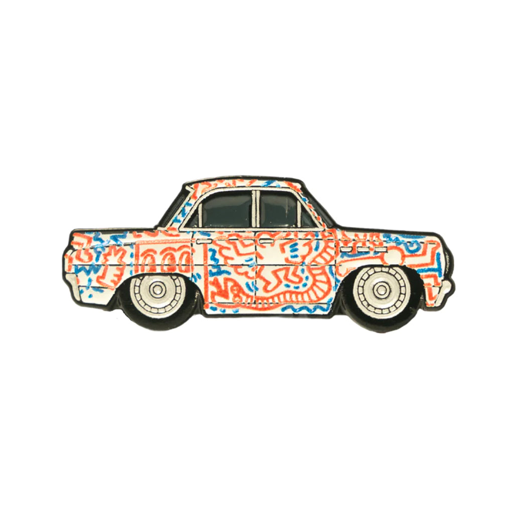 A soft enamel lapel pin depicting a Buick Special with a Keith Haring inspired livery.