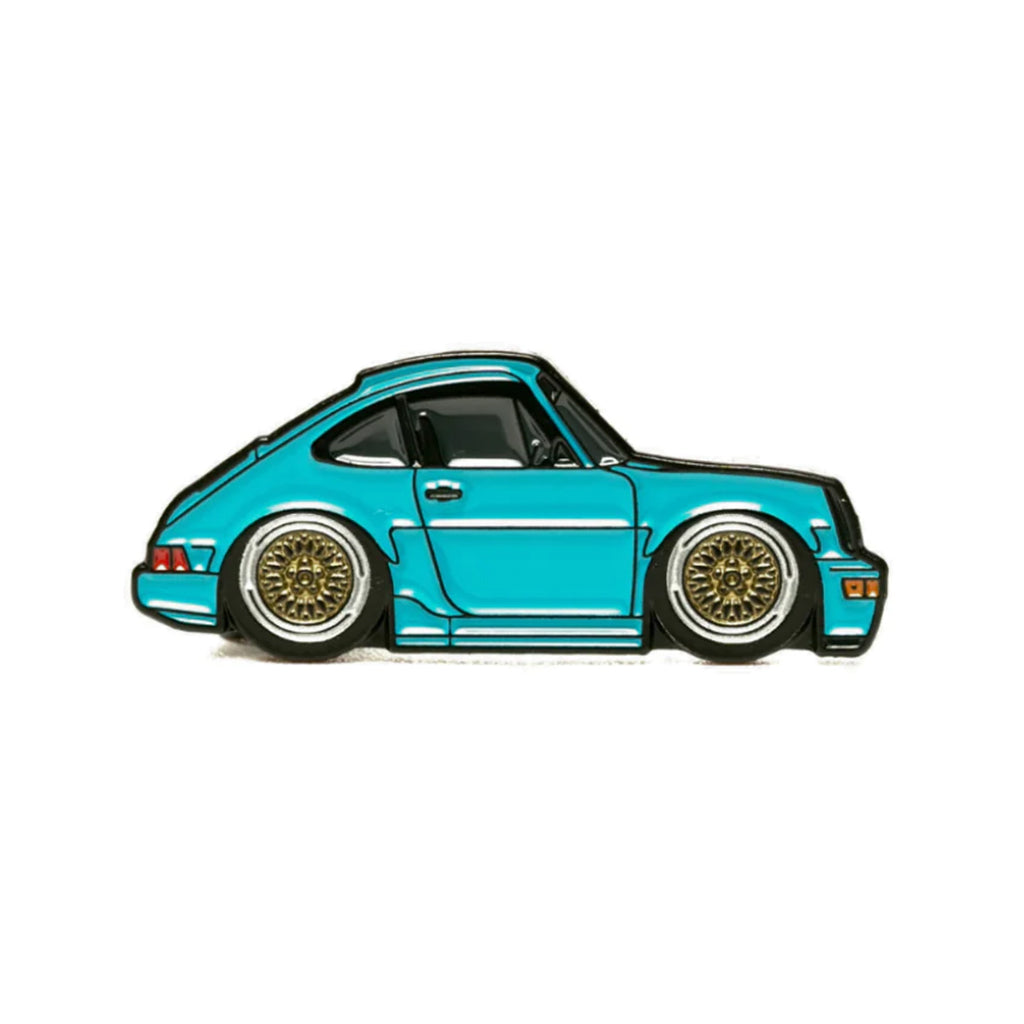 Soft enamel lapel pin of a Aqua 964 Porsche