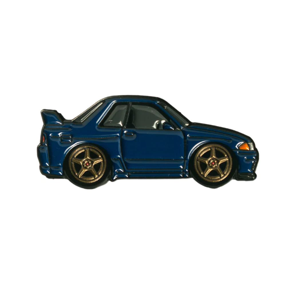 Soft enamel lapel pin of a midnight blue Nissan Skyline R32