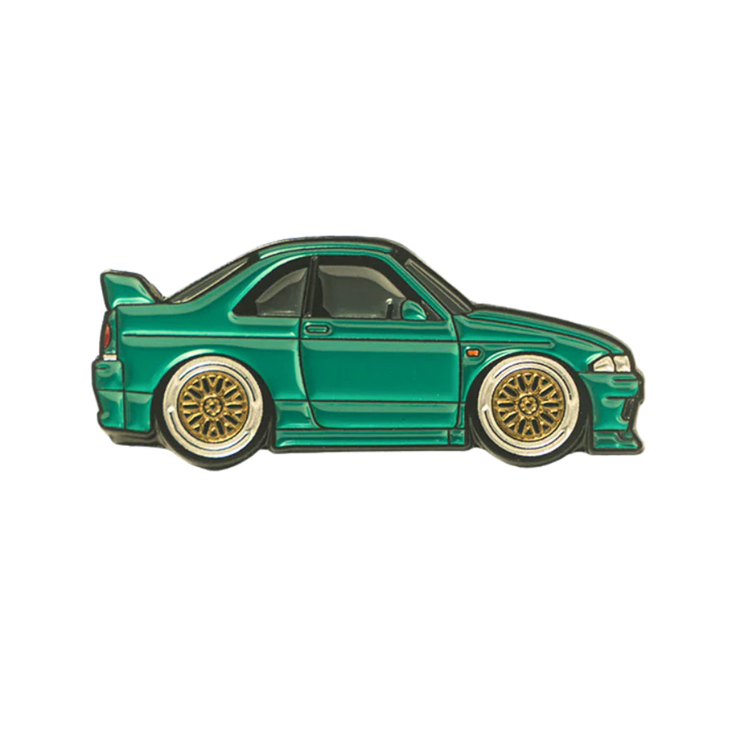 Soft enamel lapel pin of a green Nissan Skyline R33