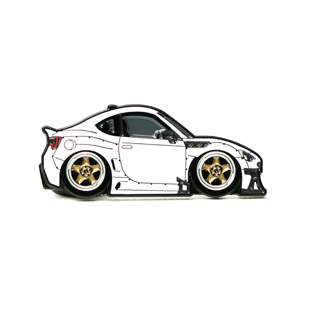 Soft enamel lapel pin of a white widebody BRZ