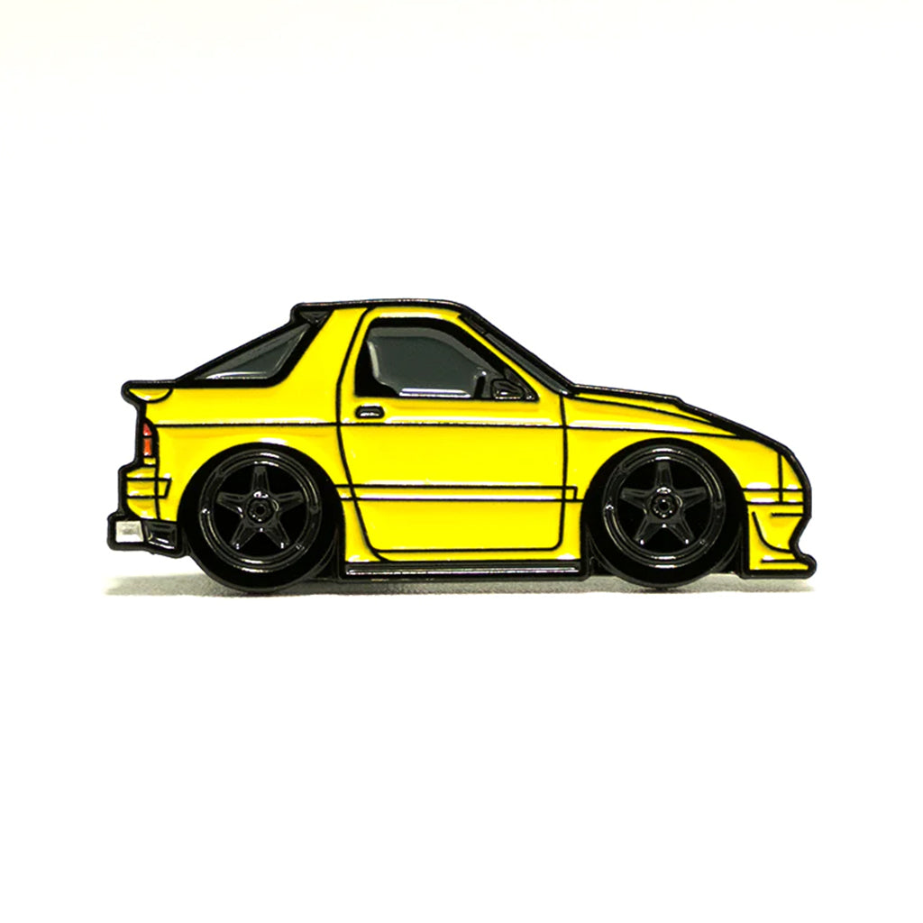 Soft enamel lapel pin of a yellow Mazda RX7 FC