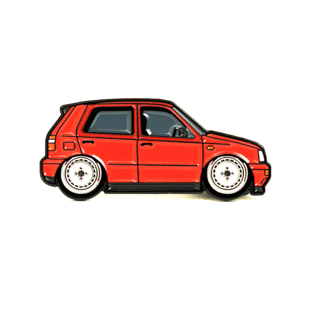 Soft enamel lapel pin of a red Volkswagen MK3 Golf