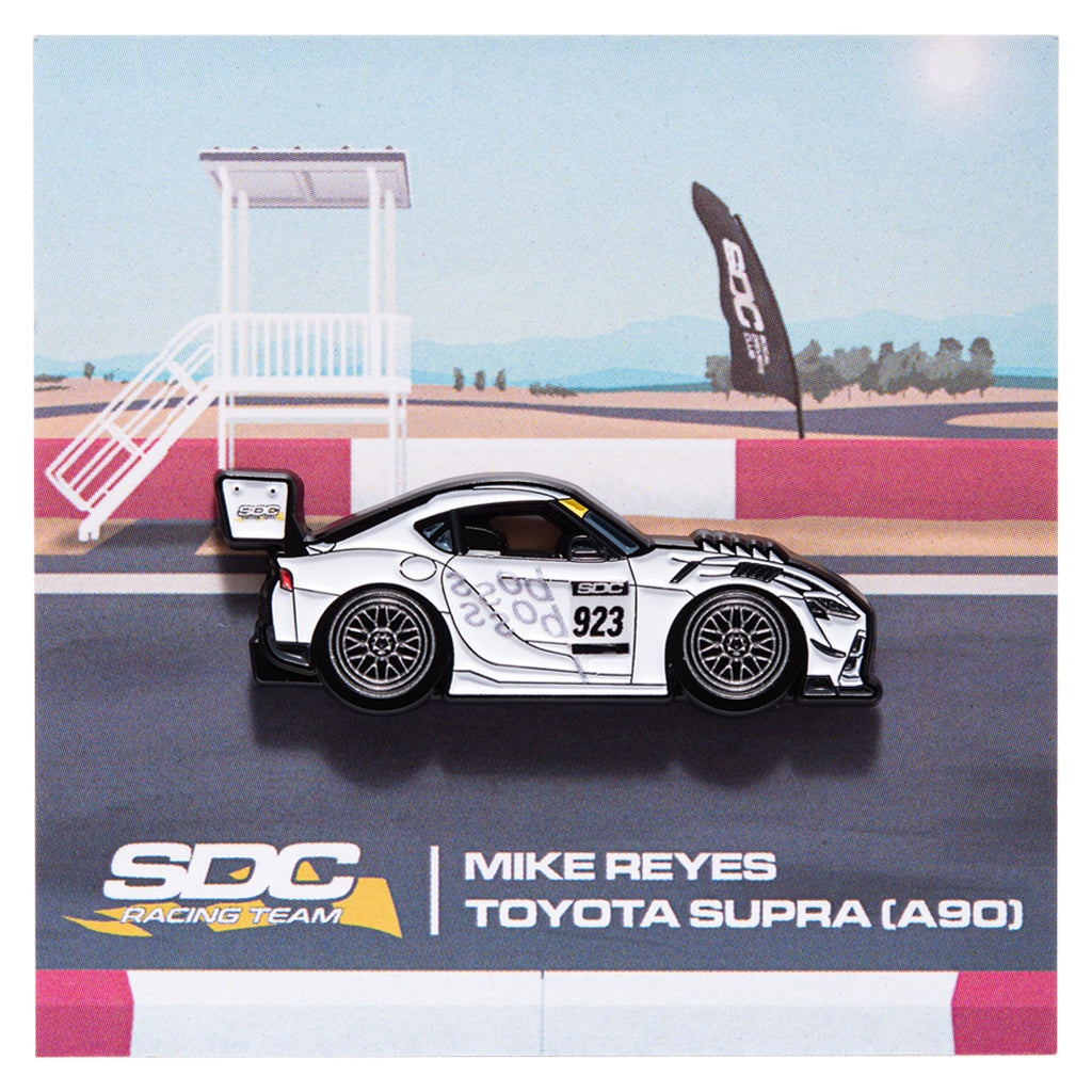 White livery Toyota A90 enamel pin on a backing card showcasing race track with SDC Racing Team, Mike Reyes lettering