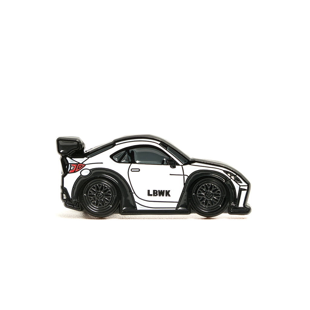Metal enamel pin of a white GR86 in white with black wheels and wing.
